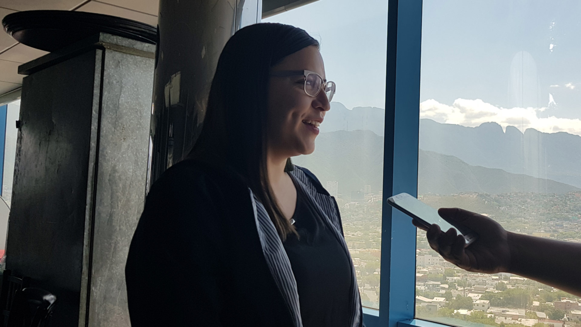 Joven siendo entrevistada con Monterrey de fondo