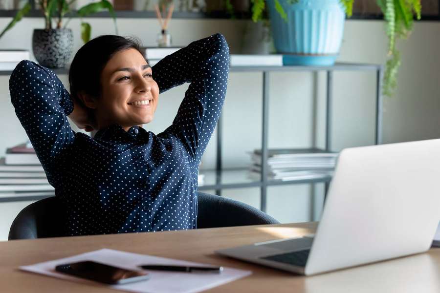 Empleada sonríendo en su escritorio de trabajo