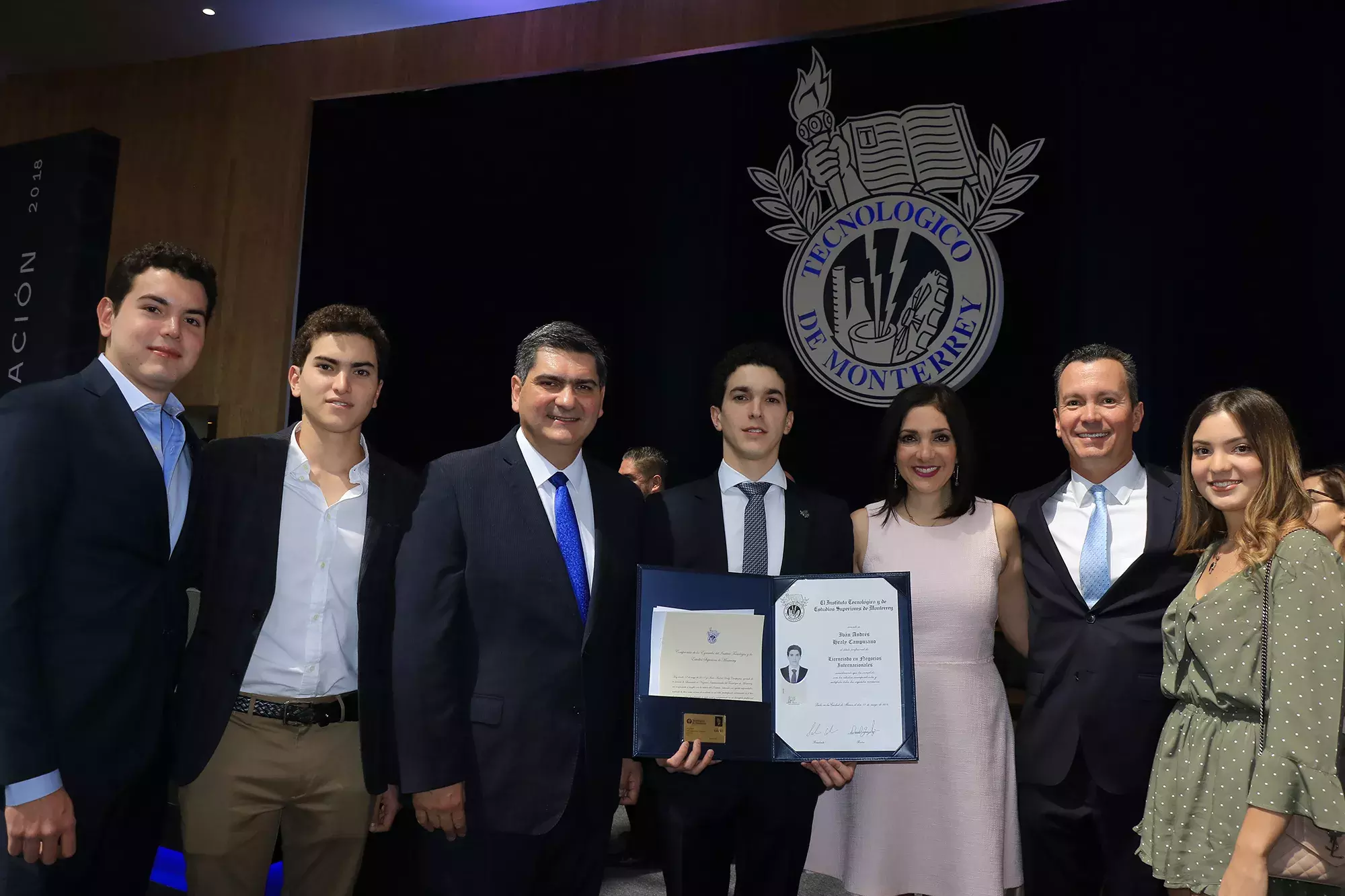 alumnos posando con el título