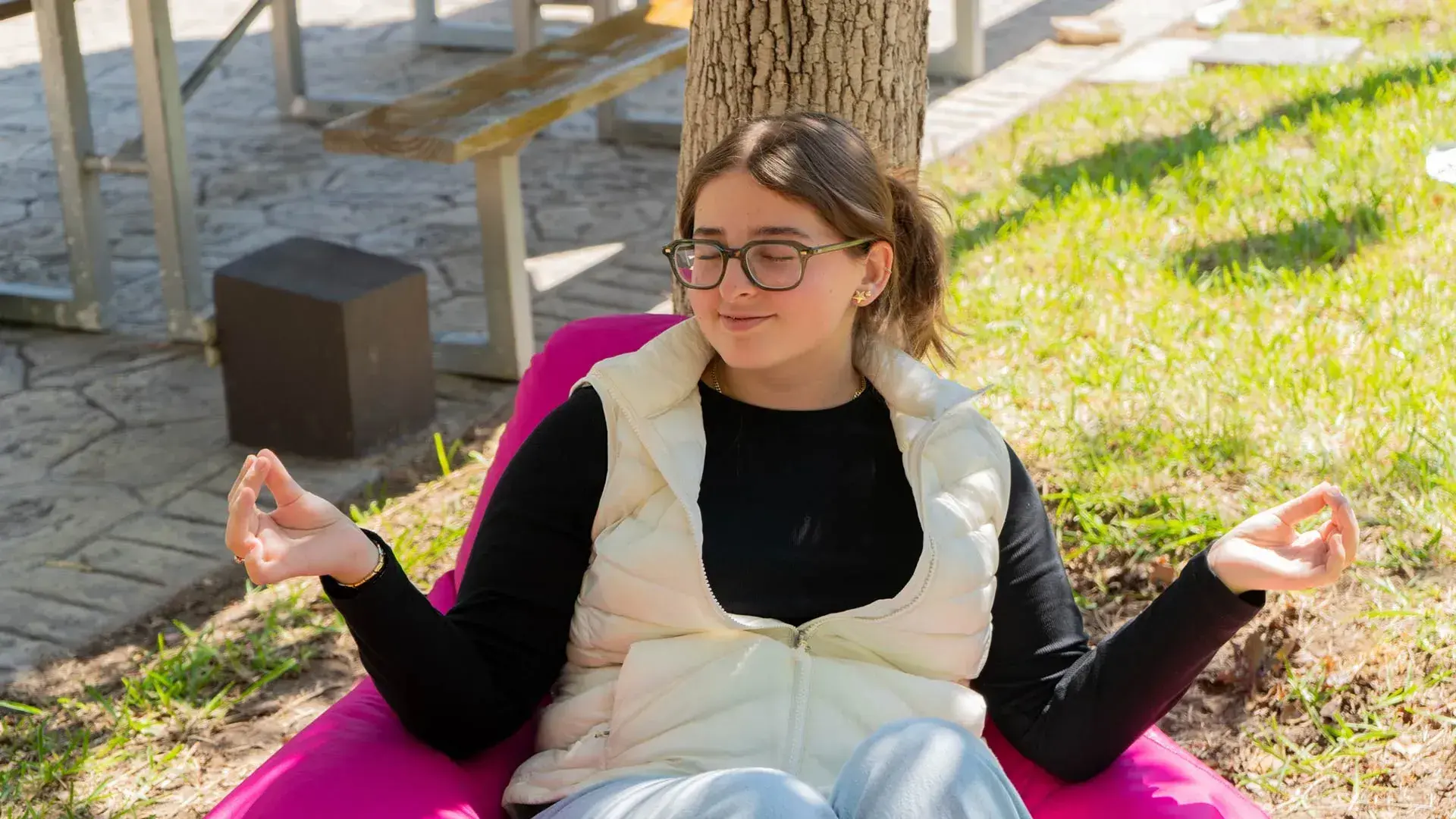 Estudiante meditando en jardín
