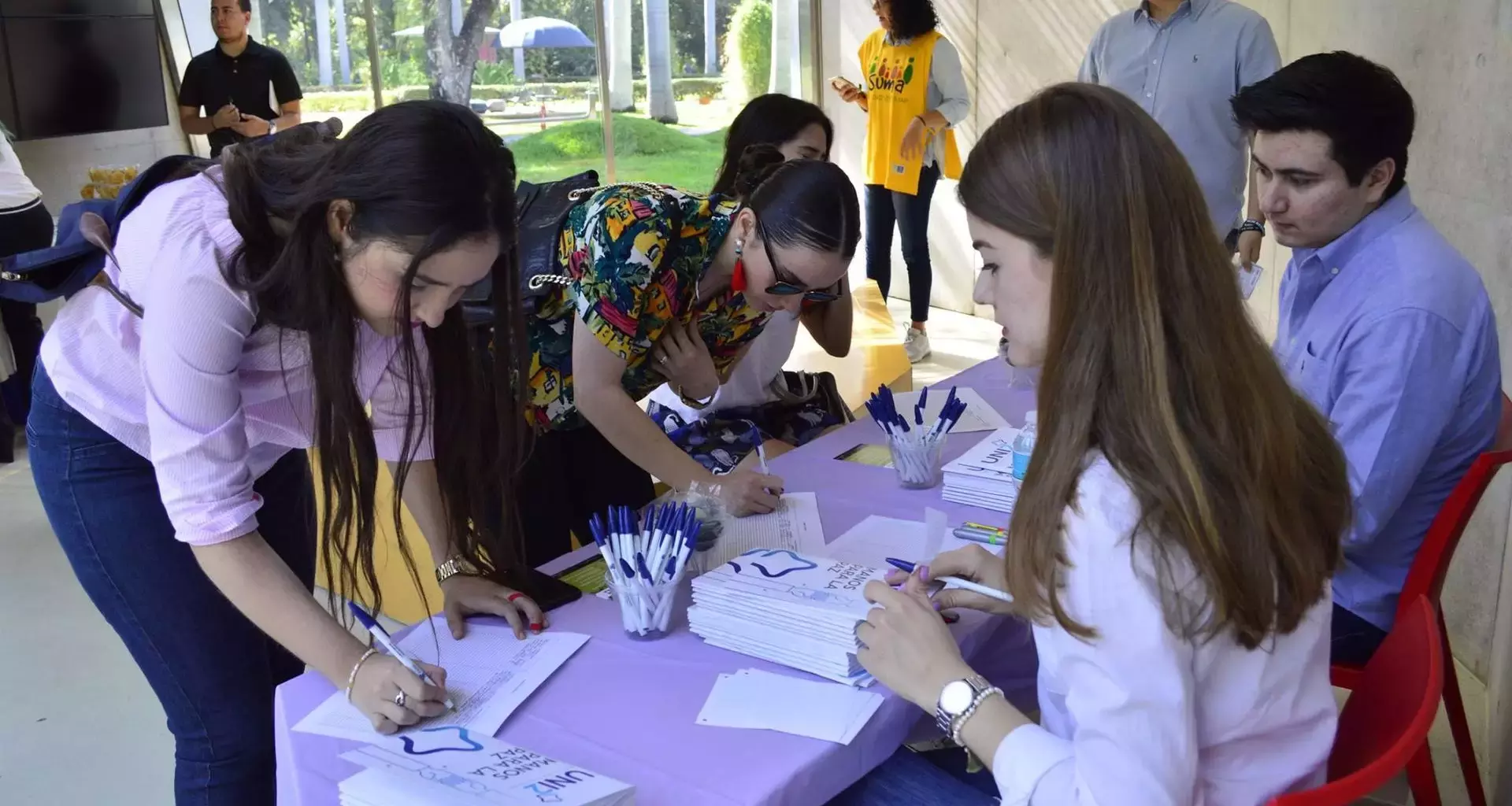 Jovenes registrandose para conferencia de UNI2