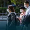 Foto de personas caminando por la calle con tapabocas