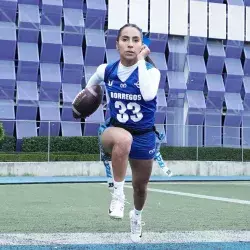 Diana Flores runs with the ovoid in a flag practice