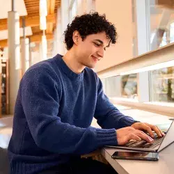 Joven estudiante utilizando su laptop