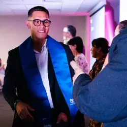 Estudiante de nivel preparatoria porta estola de graduación color azul con el logotipo de Borregos del Tec de Monterrey