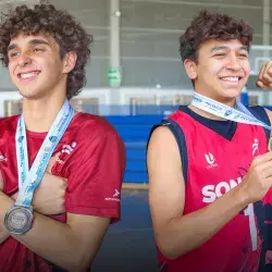 Dos jugadores de basquetbol posando con sus medallas del Nacional CONADEP en la Arena Borregos