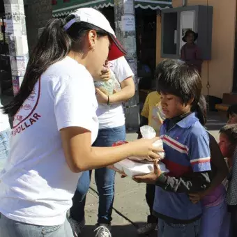 los chicos entregando las comidas