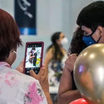 Mamá capturando foto de su hijo graduado